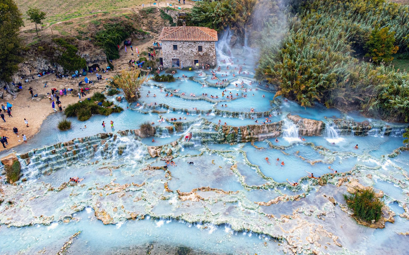 an aerial shot of the cascate del mulino in italy