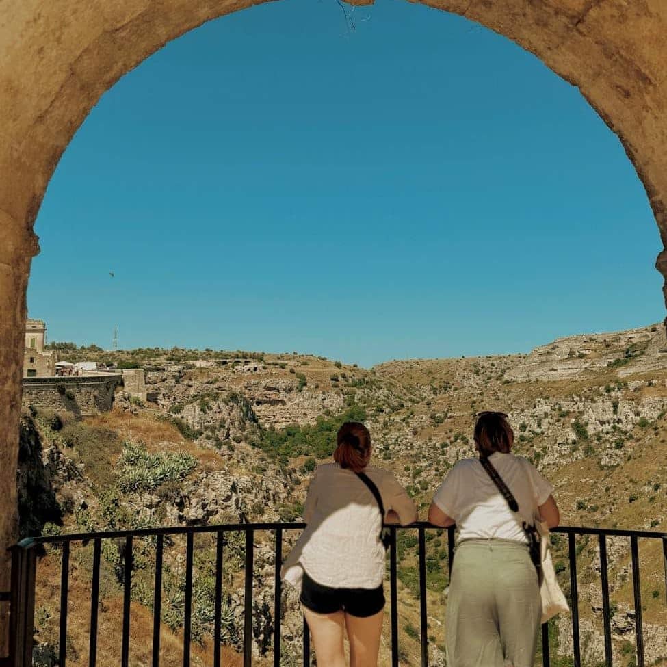 scenic view of matera through ancient archway - dolce vita